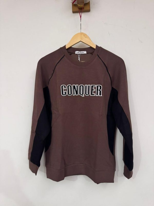 brown/maroon long-sleeve sweatshirt with "CONQUER"